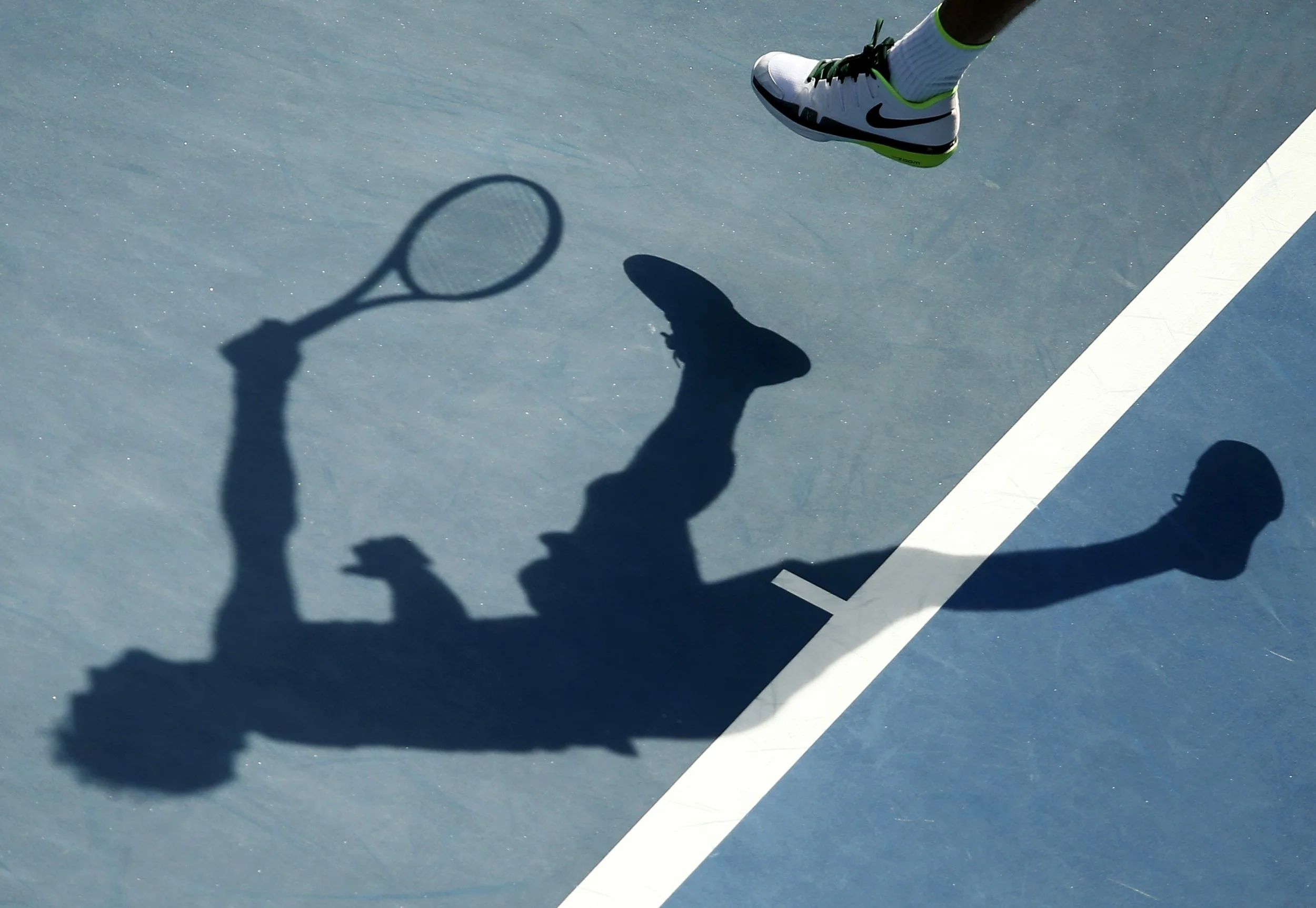 Roger Federer casts a shadow as he serves in the 2016 Australian Open. After damning allegations of match-fixing have rocked the integrity of world tennis, the future of the sport remains in the dark. Image supplied by Action Images. 