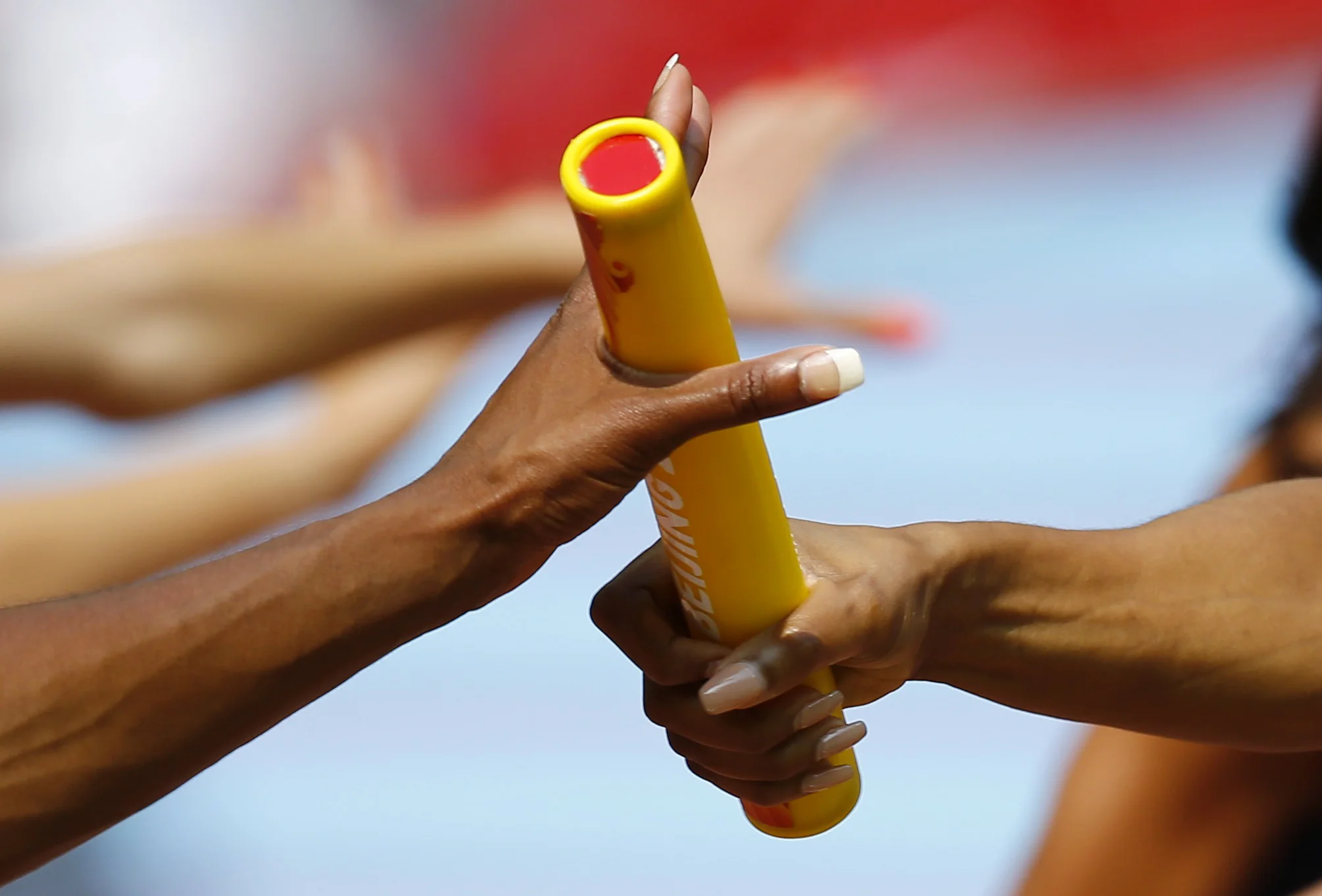 A member of the U.S. team passes the baton to her teammate during their women's 4 x 400 metres relay heat at the 15th IAAF Championships at the National Stadium in Beijing, China August 29, If coaches could pass on knowledge as seamlessly and efficiently as this, the long term benefits could be staggering. Image supplied by Action Images / Kai Pfaffenbach.