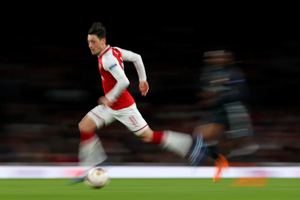 Arsenal's Mesut Ozil ghosts past a CSKA Moscow defender in a Europa League match. 