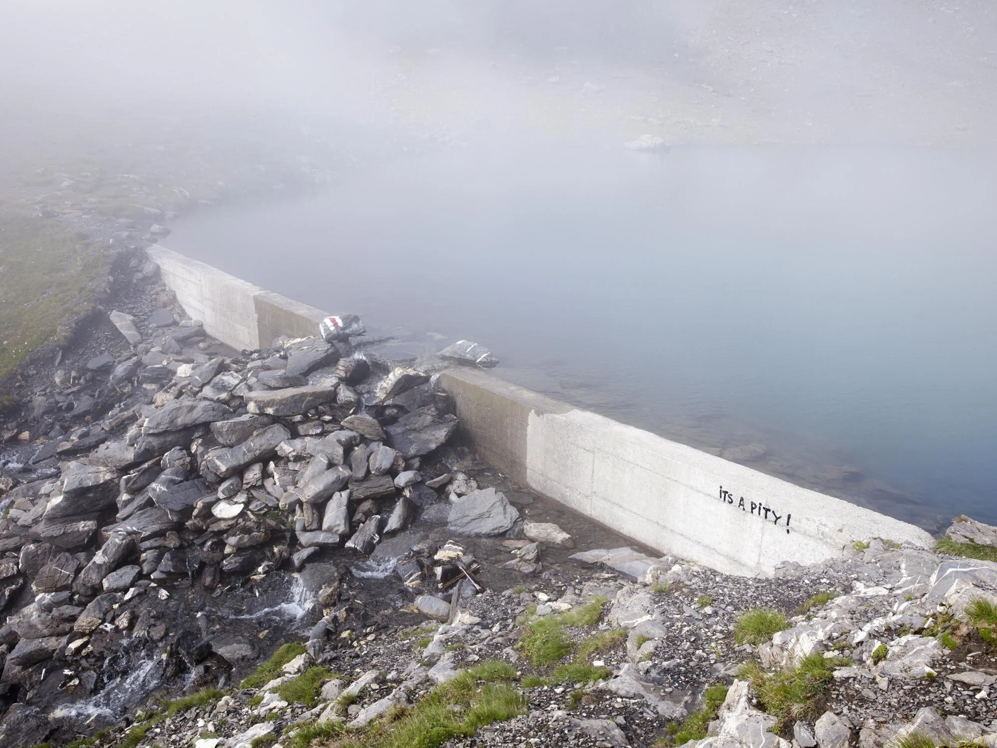 It’s a pity, written on a dam made of concrete in the Schilthorn area in Switzerland