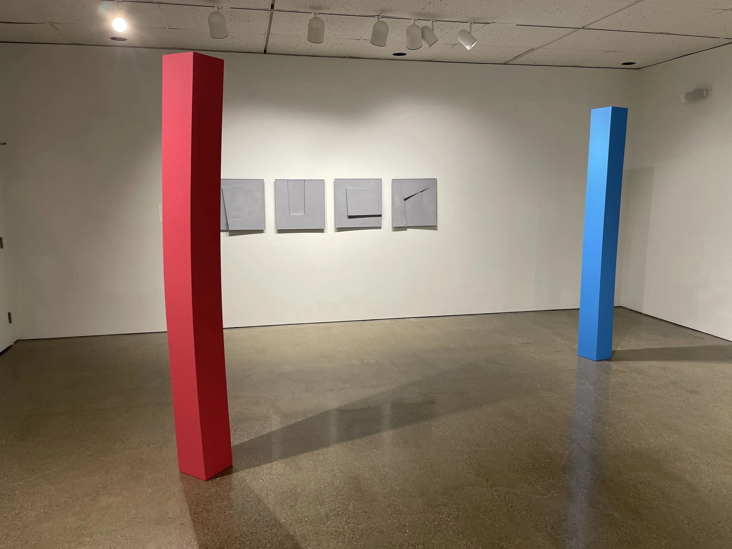   LEFT: Lodestone (High Dive) , 2025. Enamel on shaped wood. 96 x 9 x 9 inches.    RIGHT: Lodestone (Roulette) , 2025. Enamel on shaped wood. 96 x 9 x 9 inches.   The titles  High Dive  and  Roulette  suggest two distinct forms of risk: one involving