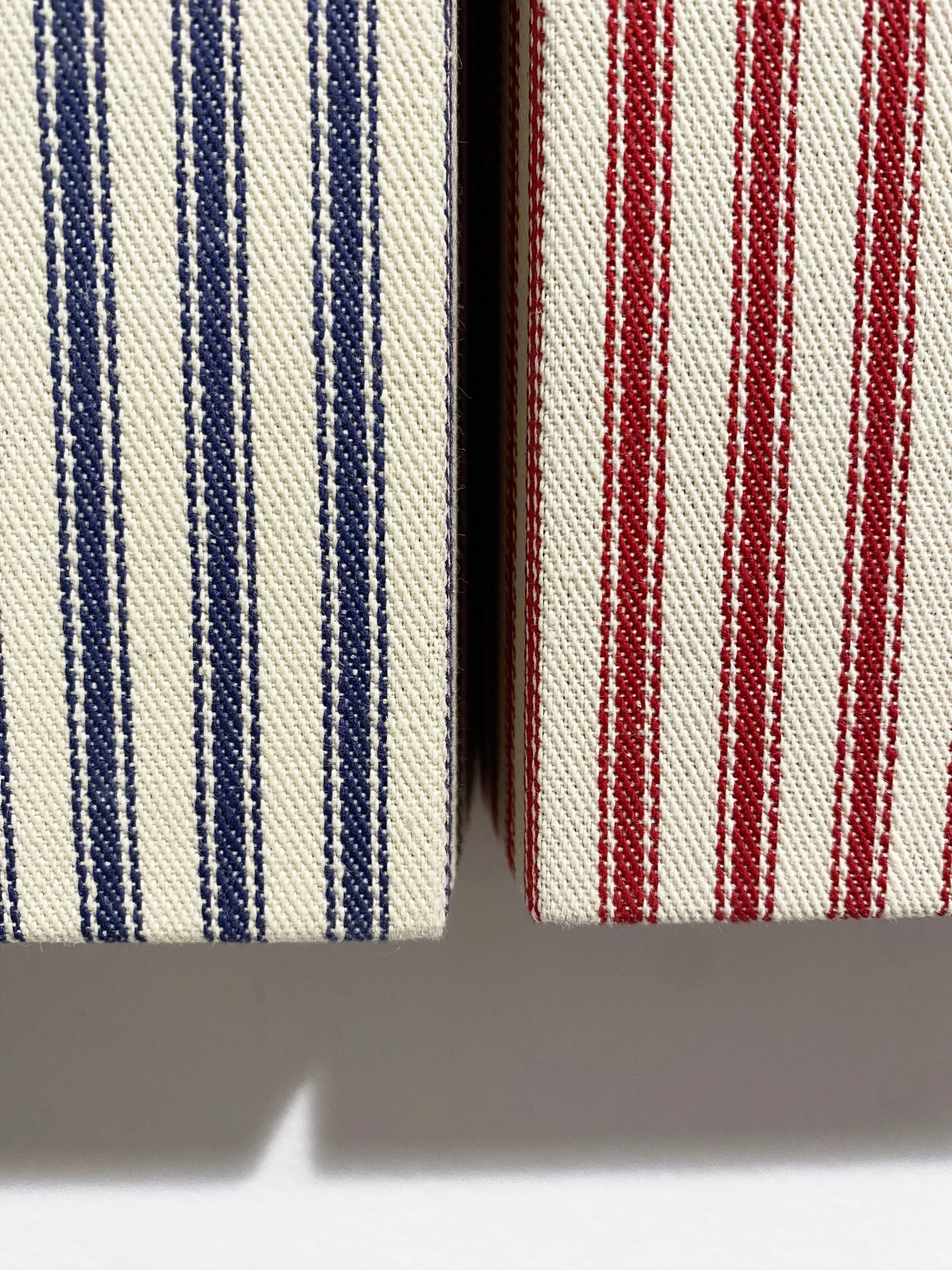 Sentimental X’s , 2025. Mattress ticking on uniquely shaped wood panel; two elements: 11 × 12 inches each.