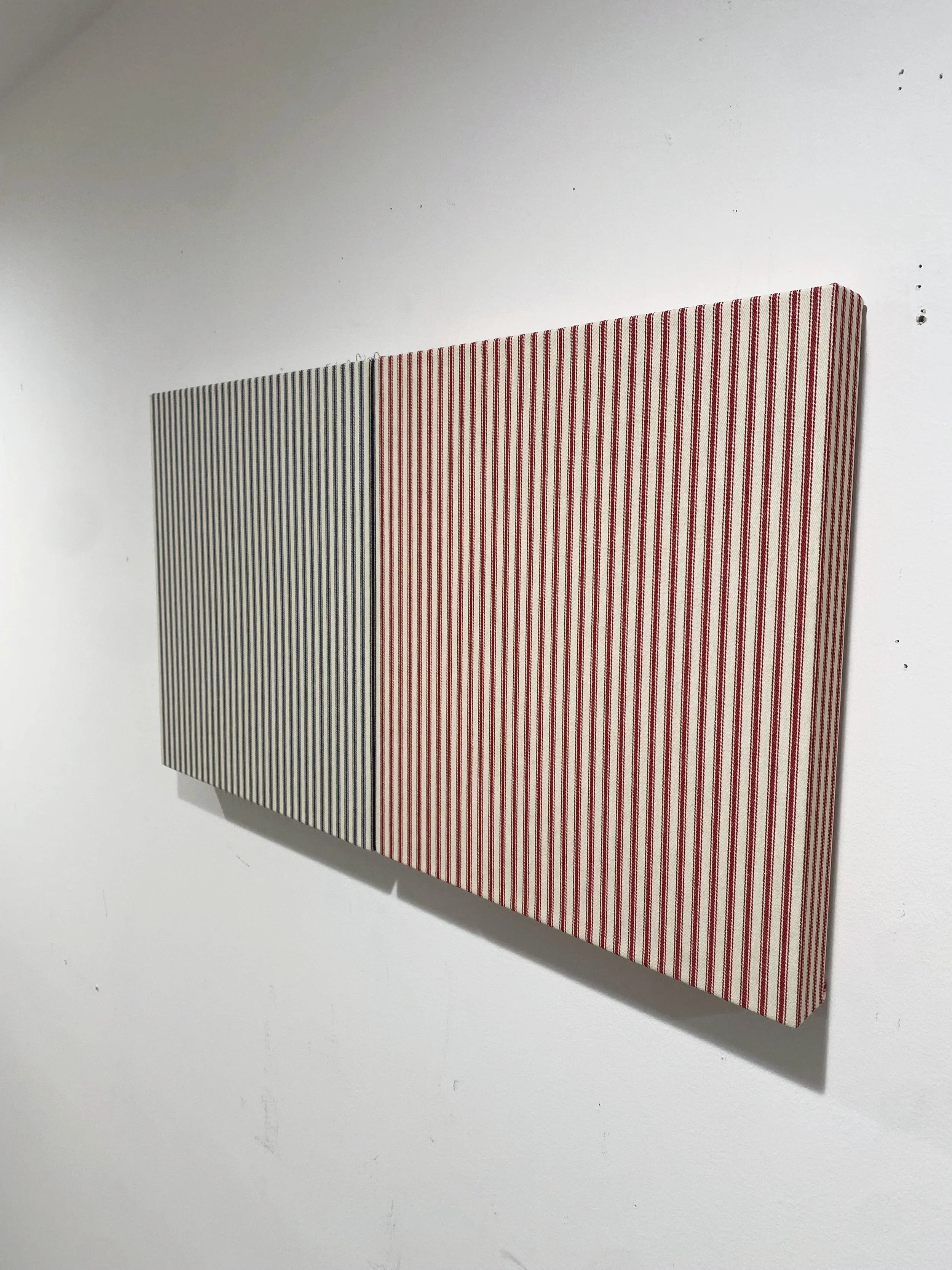   Sentimental X’s , 2025. Mattress ticking on uniquely shaped wood panel; two elements: 11 × 12 inches each. 