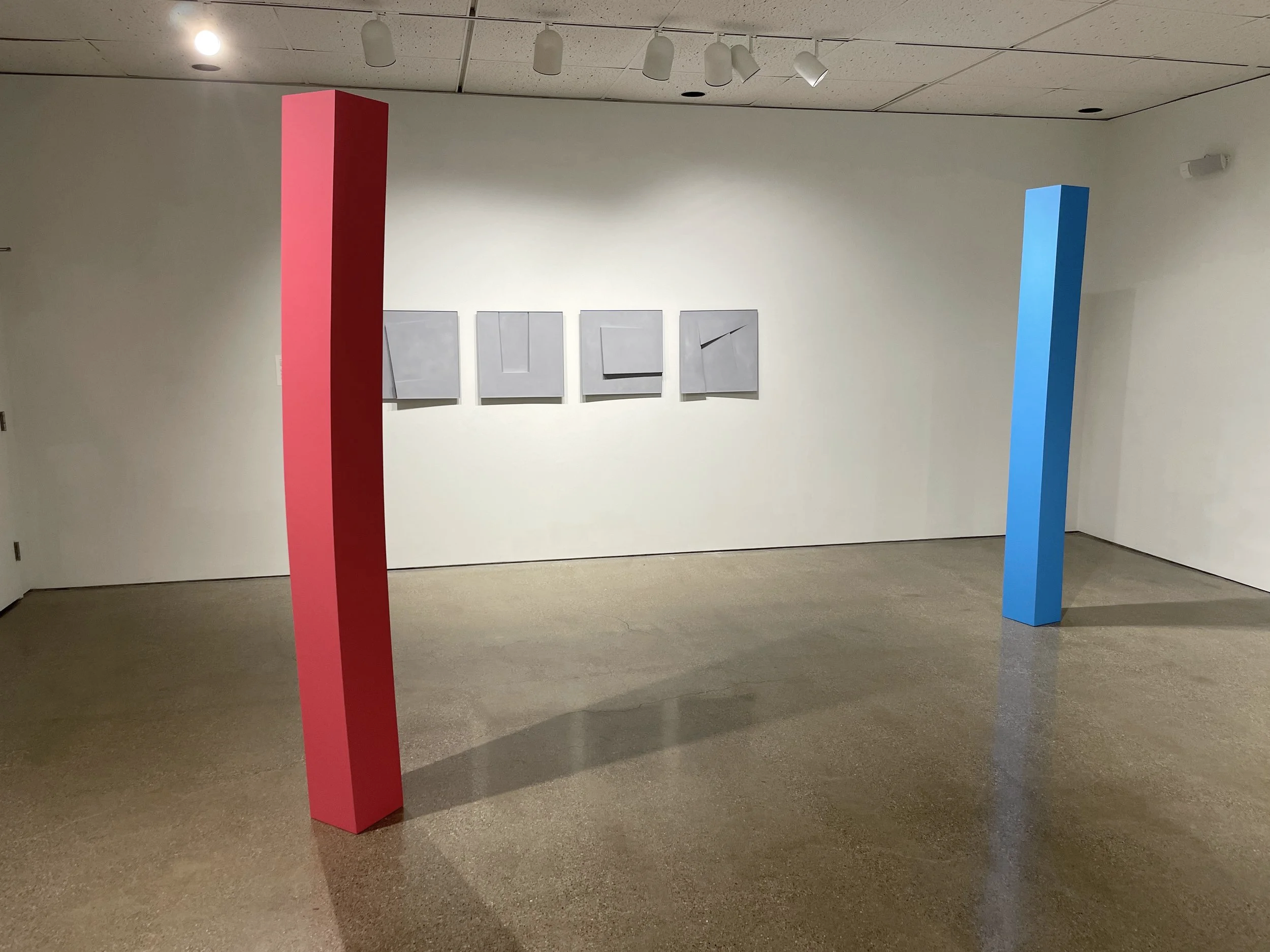   LEFT: Lodestone (High Dive) , 2025. Enamel on shaped wood. 96 x 9 x 9 inches.    RIGHT: Lodestone (Roulette) , 2025. Enamel on shaped wood. 96 x 9 x 9 inches.   The titles  High Dive  and  Roulette  suggest two distinct forms of risk: one involving