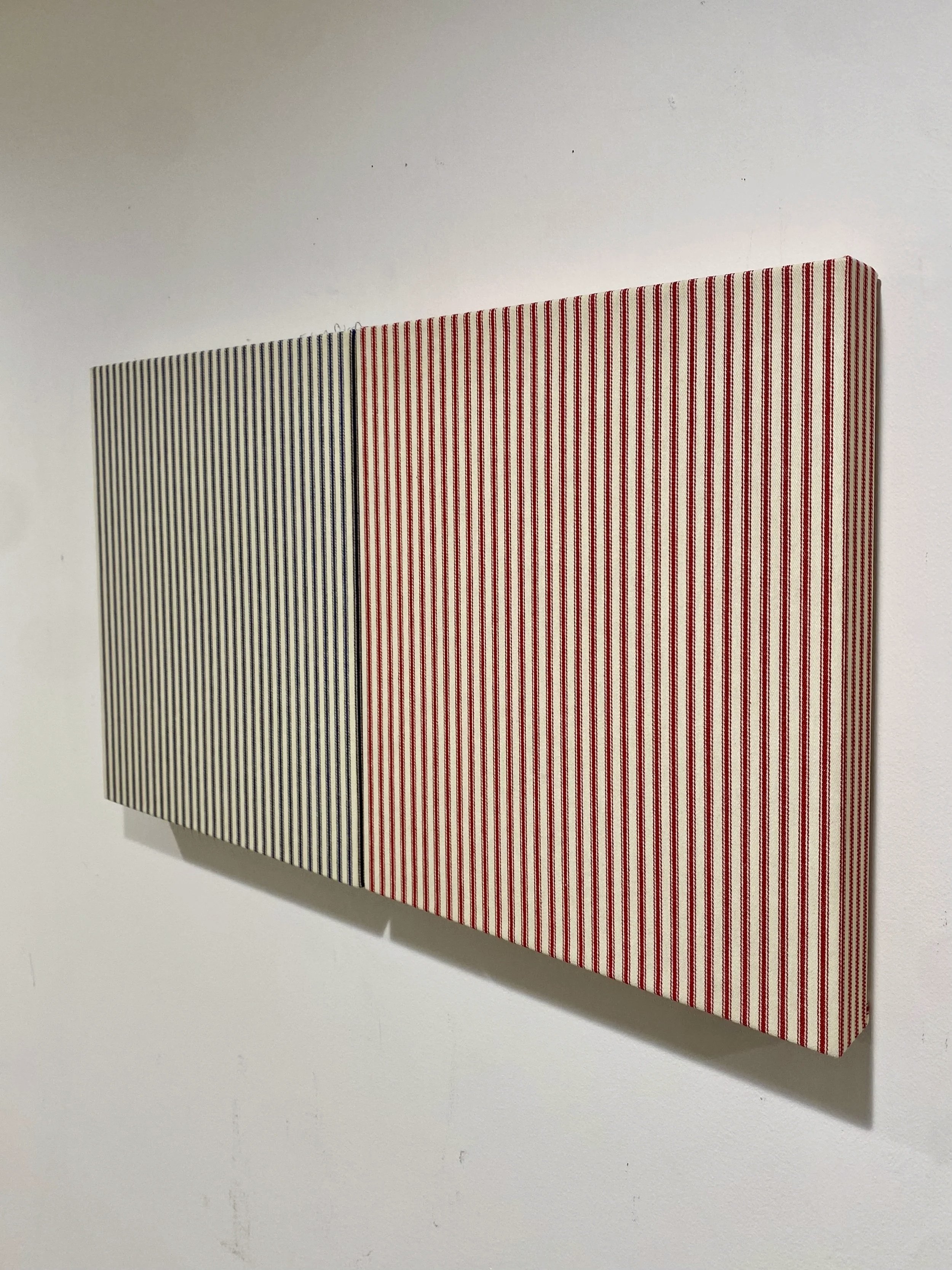   Sentimental X’s , 2026. Mattress ticking on uniquely shaped wood panel; two elements: 11 × 12.25 inches each, 1 1 × 23 inches overall. 