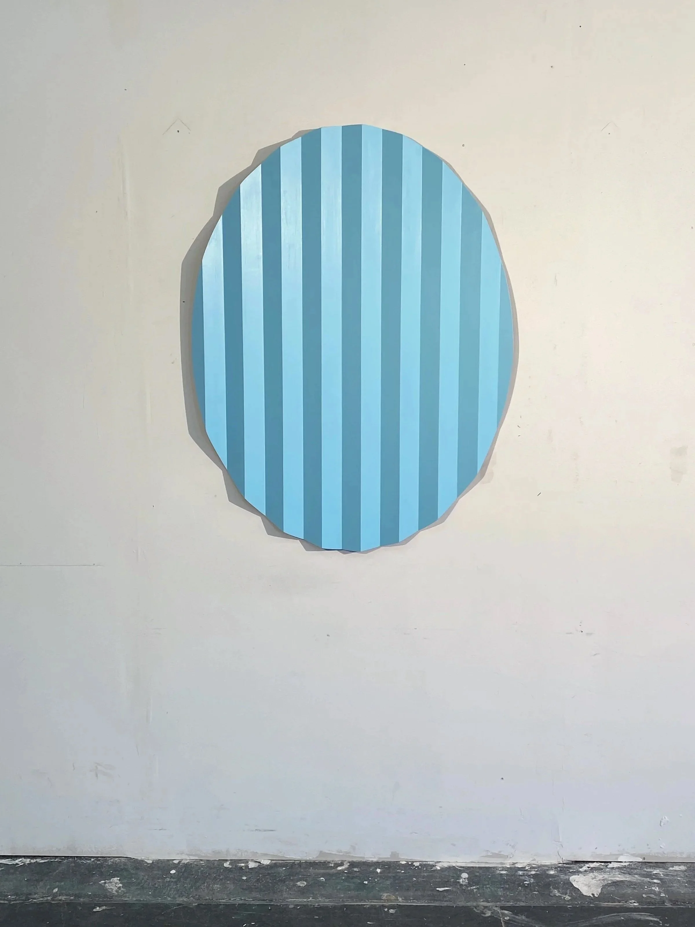 Enfolding Form II , 2025. Enamel on uniquely shaped wood relief. 32 x 43 inches. The form evokes the changing shapes of the sun and moon, their cycles of disappearance and return, as a metaphor for longing, memory, and the hope of reunion despite