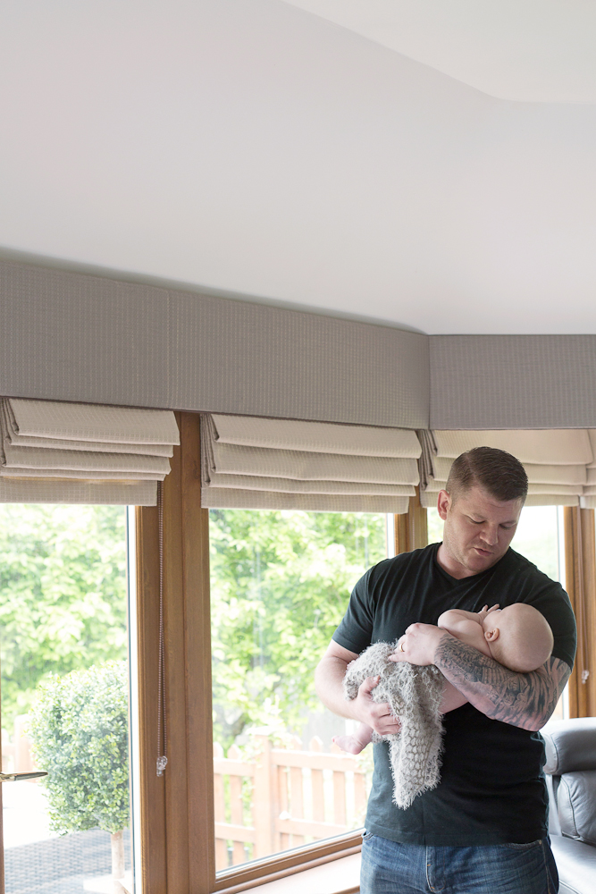 dad holding newborn baby