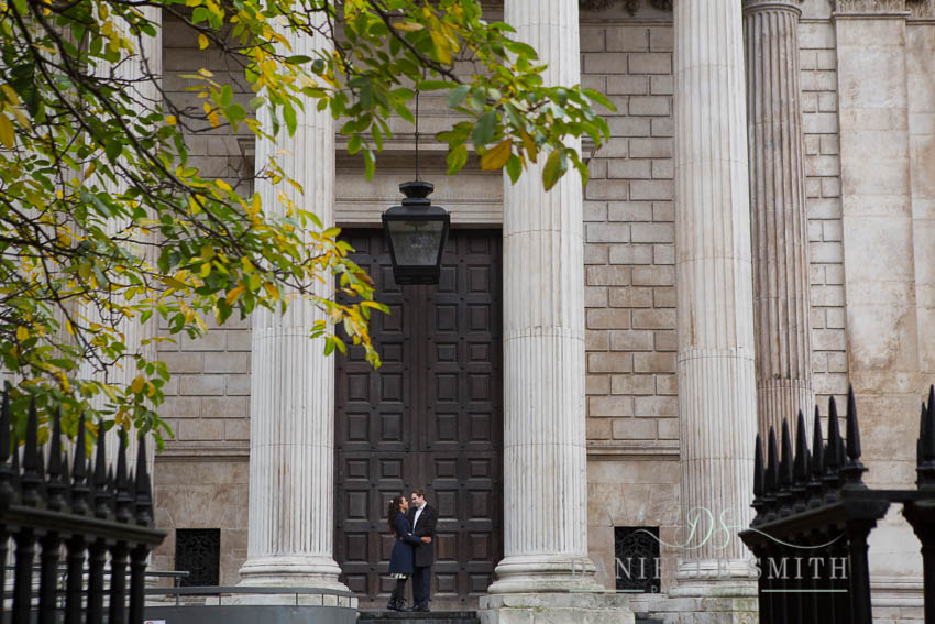 couple standing in front of huge doors at st pauls