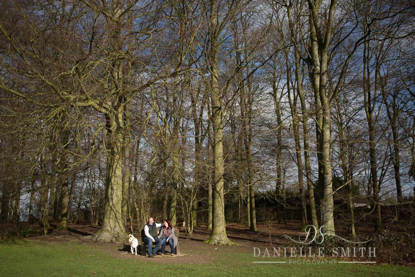 couple and their dog in woodland engagement photography session