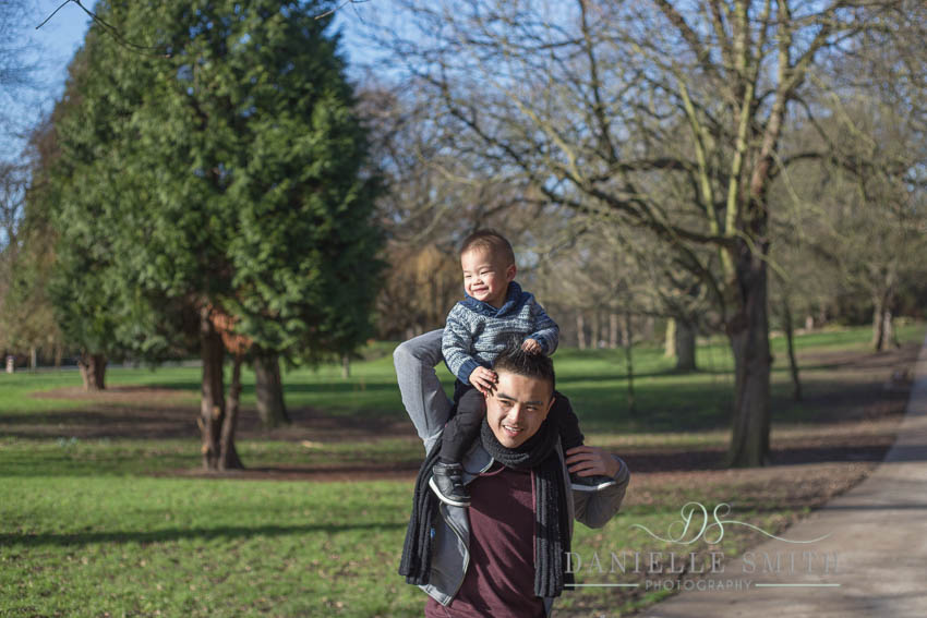 little boy on dads shoulders