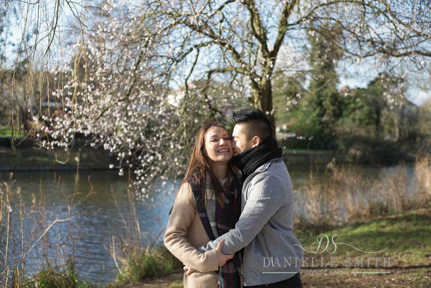 couple laughing under blossom