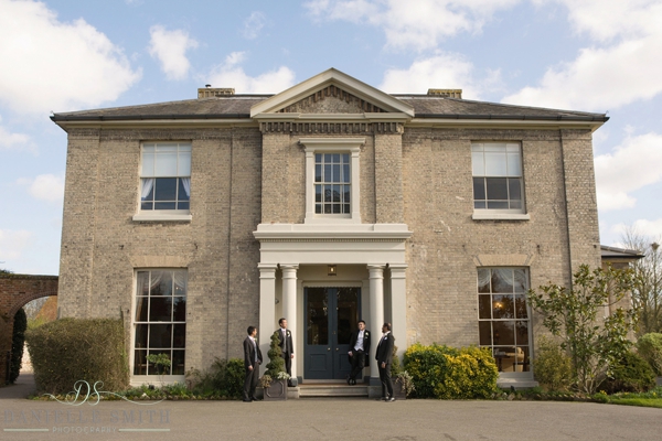 groom and groomsmen outside the fennes