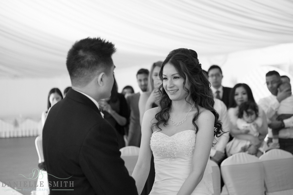 bride smiling at groom during ceremony