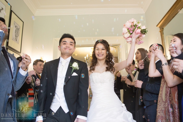 bride and groom with bubbles at the fennes