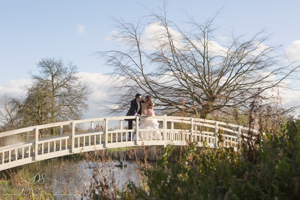 bride and groom on bridge at the fennes