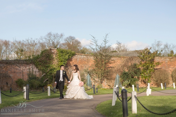 bride and groom walking down path