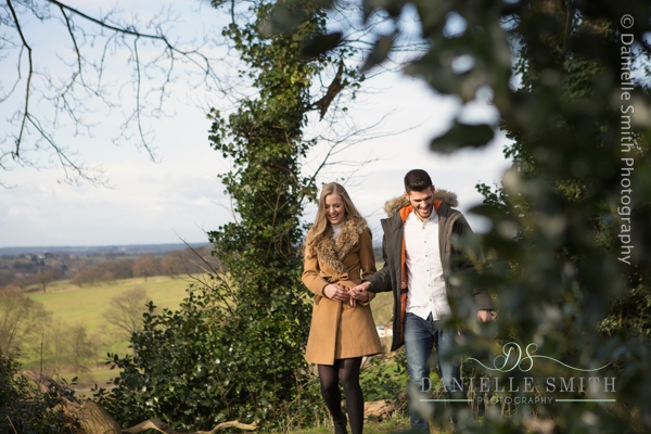 couple walking through trees