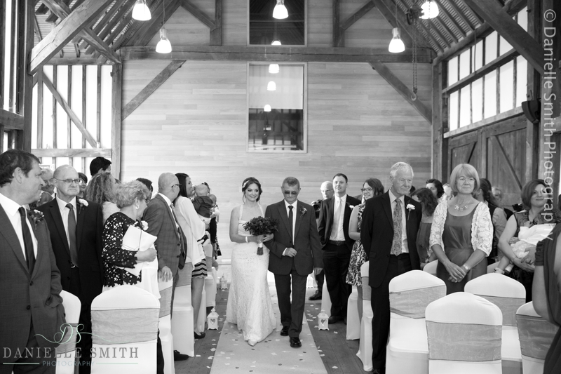 dad walking daughter down the aisle at barn wedding