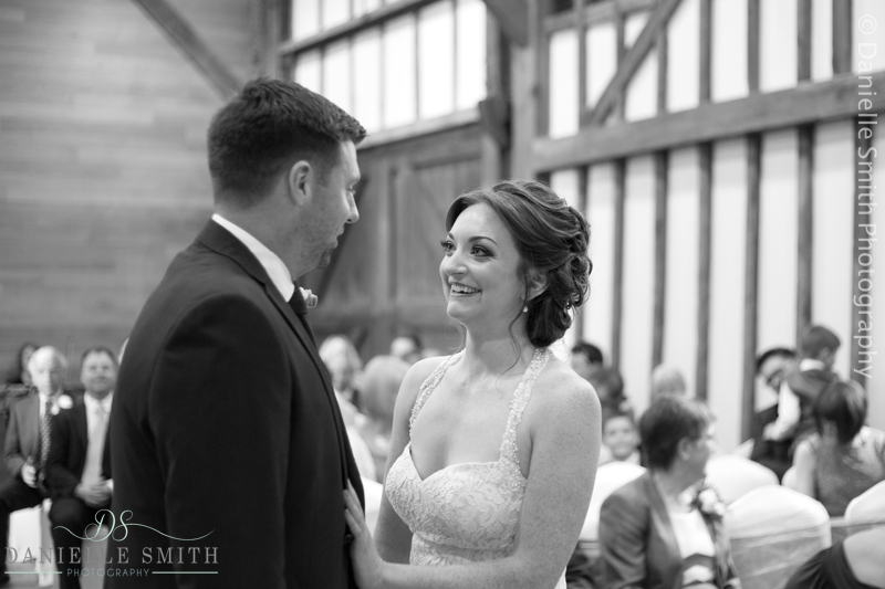 bride and groom during ceremony - barn wedding in purfleet