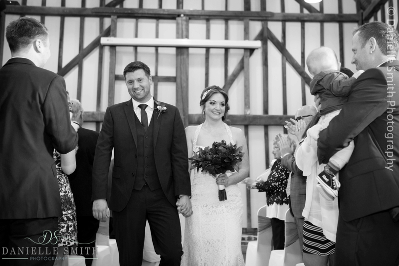 bride and groom walking down the aisle at high house production park