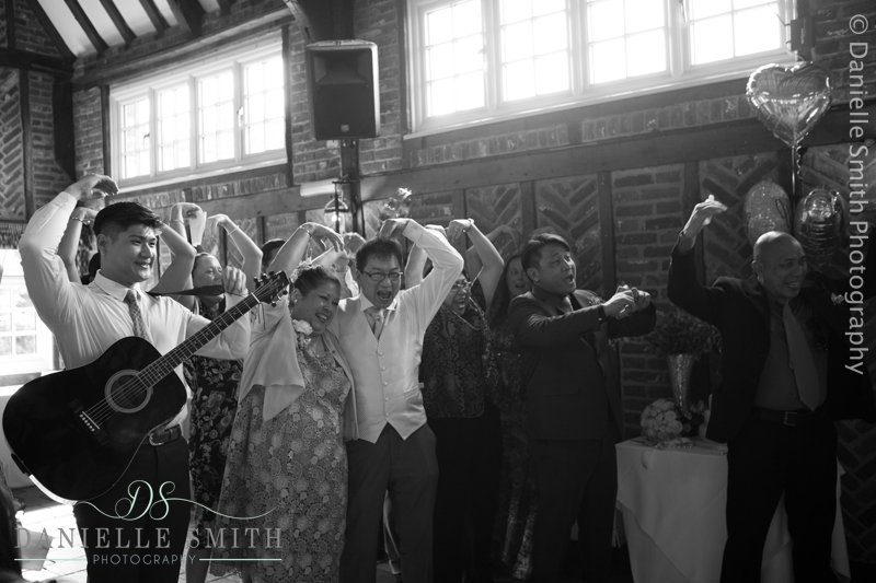 family perform song and dance at wedding