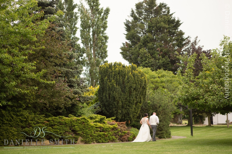 bride and groom walking into gardens