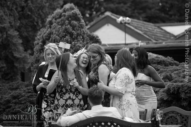 group of friends having selfie at wedding