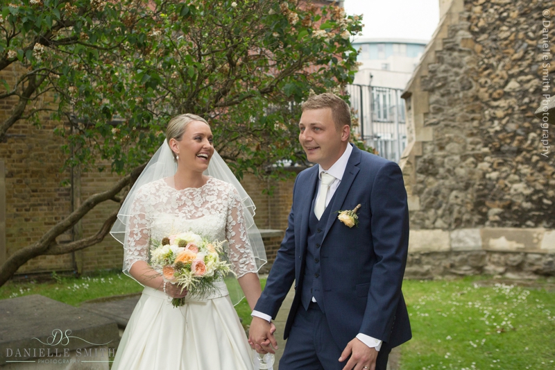 bride and groom laughing outside church