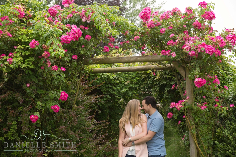 couple with bright pink flower pergola