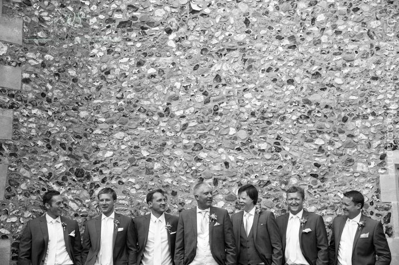 groom and groomsmen outside the church wall
