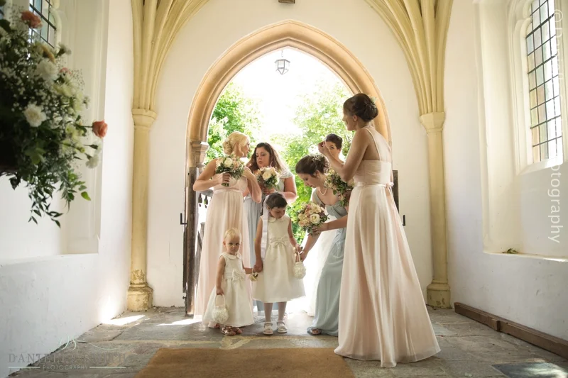 bride and bridesmaids waiting in church doorway