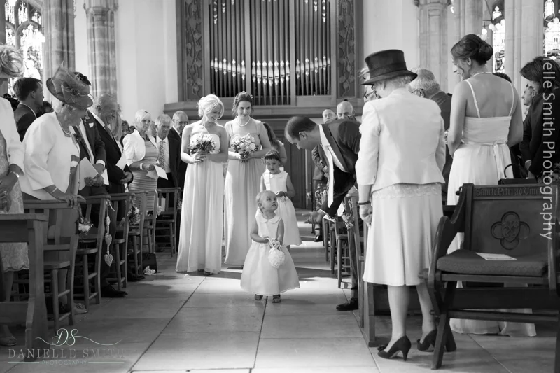 bridesmaids and flower girls walking down aisle