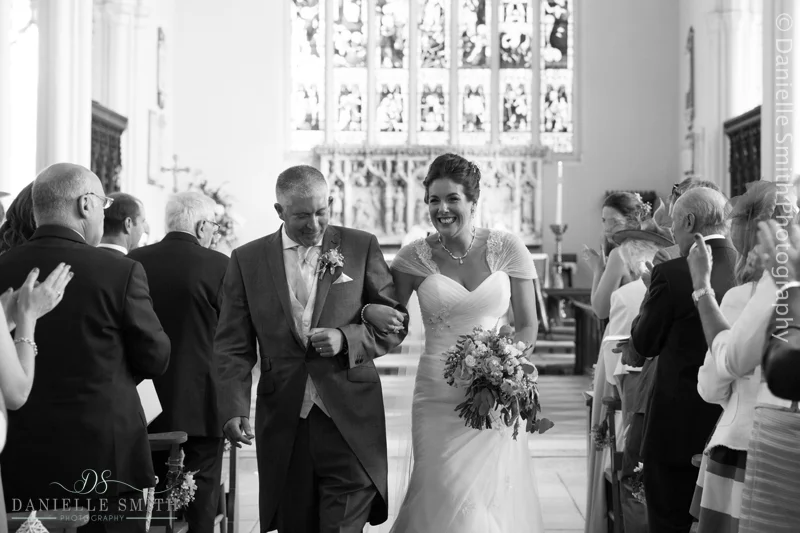 bride and groom walking down aisle - creative documentary wedding photography