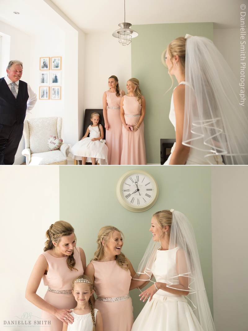 dad and bridesmaids seeing bride in her dress