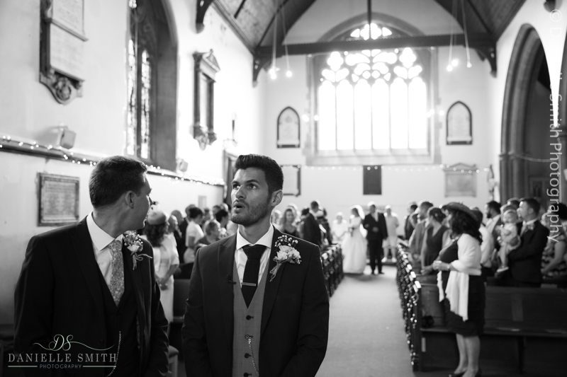 groom waiting for bride at front of aisle