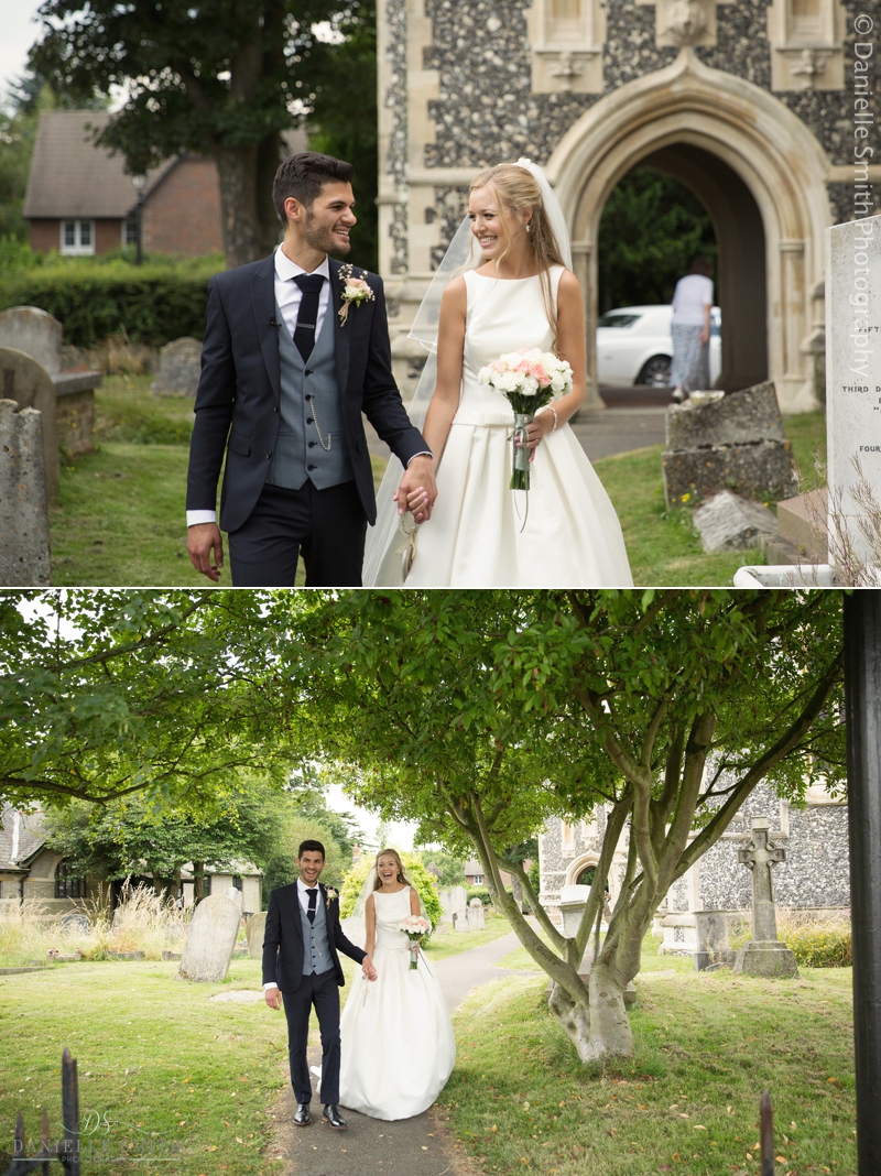 bride and groom walking through church gardens