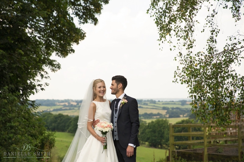 bride and groom with view of fields behind - havering-atte-bower