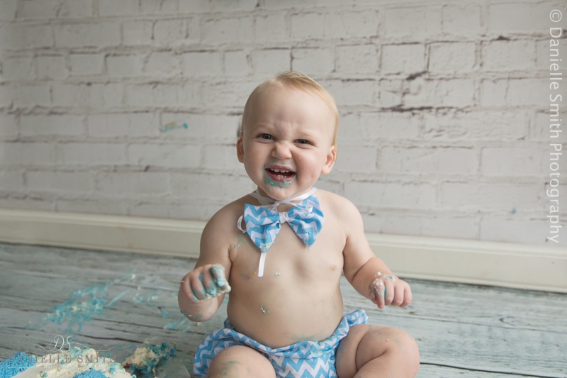 boy smiling with cake round mouth