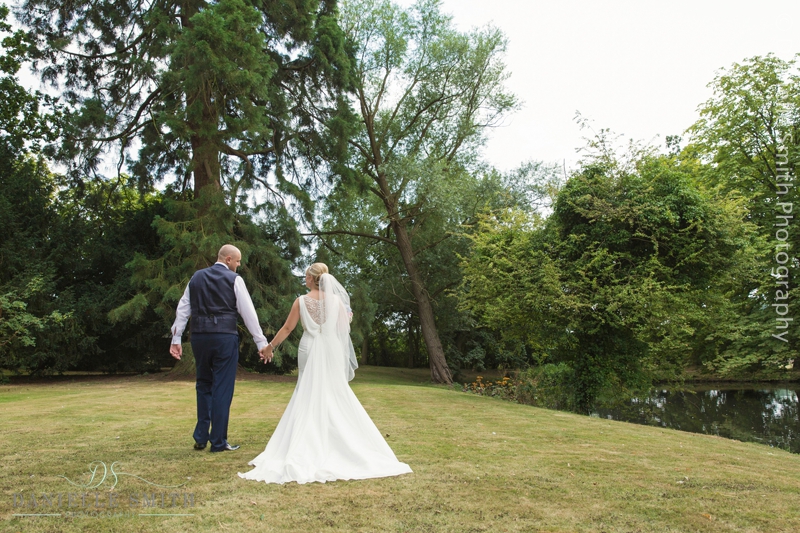 bride and groom walking away at summer wedding