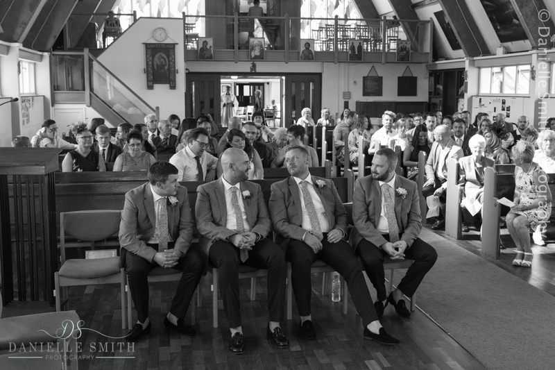 groom and groomsmen waiting in church