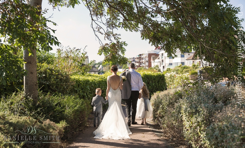 bride and groom and children walking away