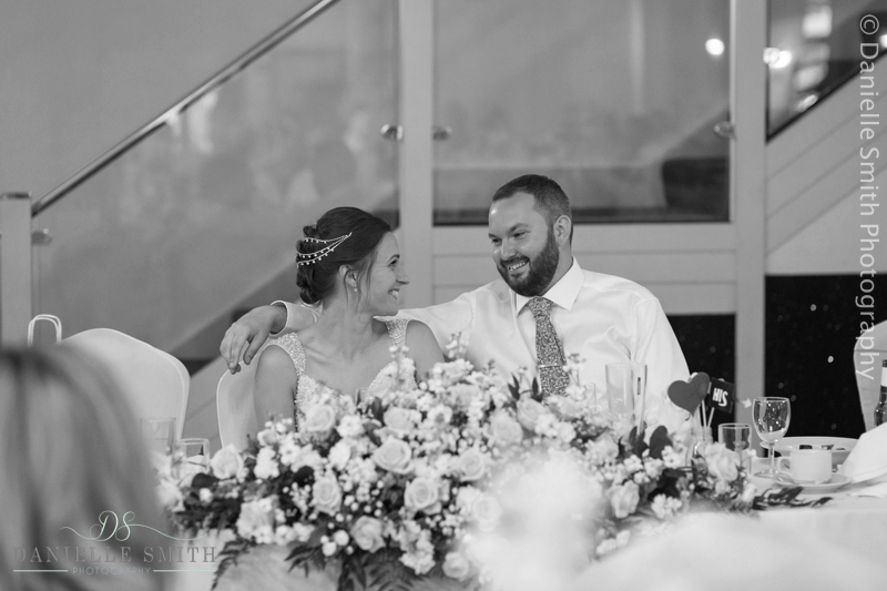 bride and groom sitting at table