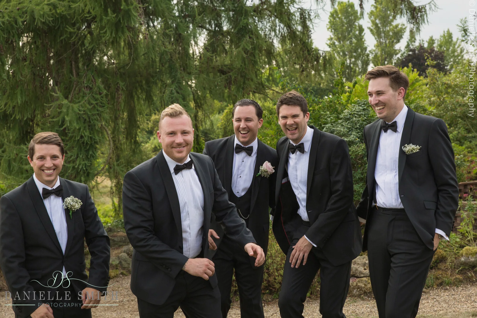groom and groomsmen messing around - summer garden wedding