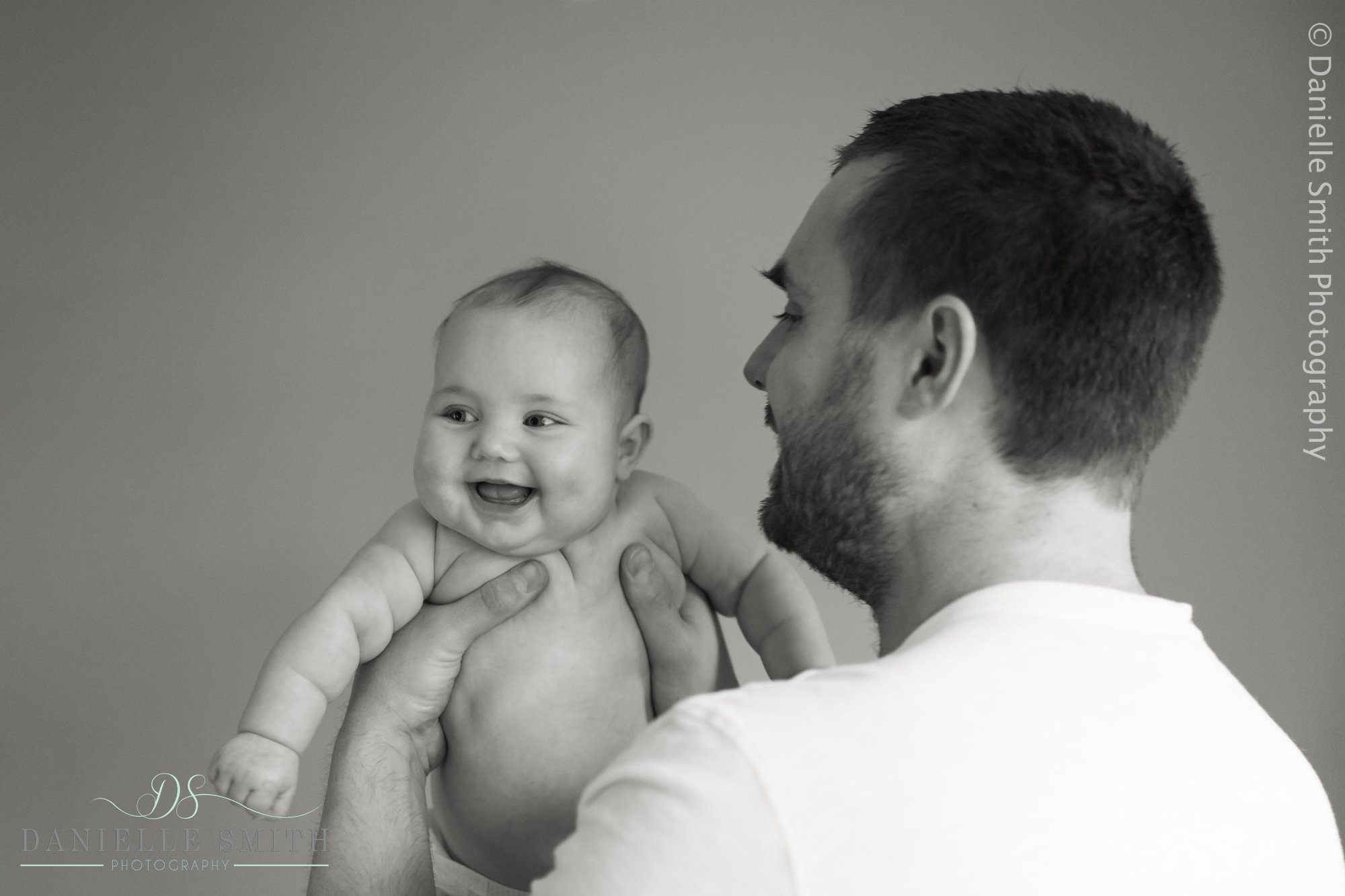 baby girl laughing in daddy arms