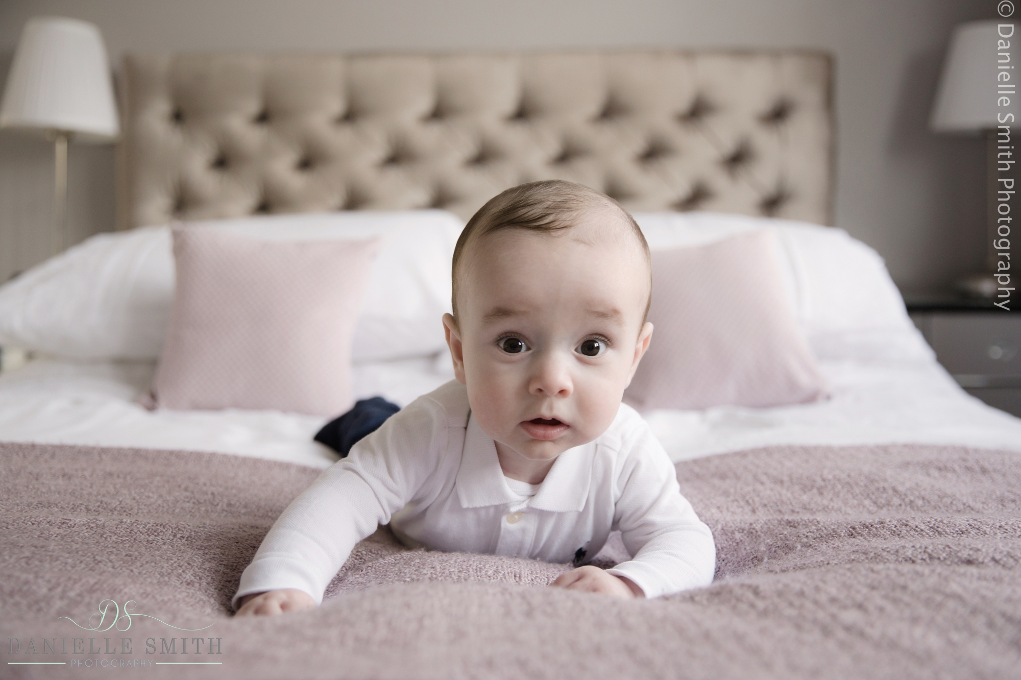 baby boy laying on bed