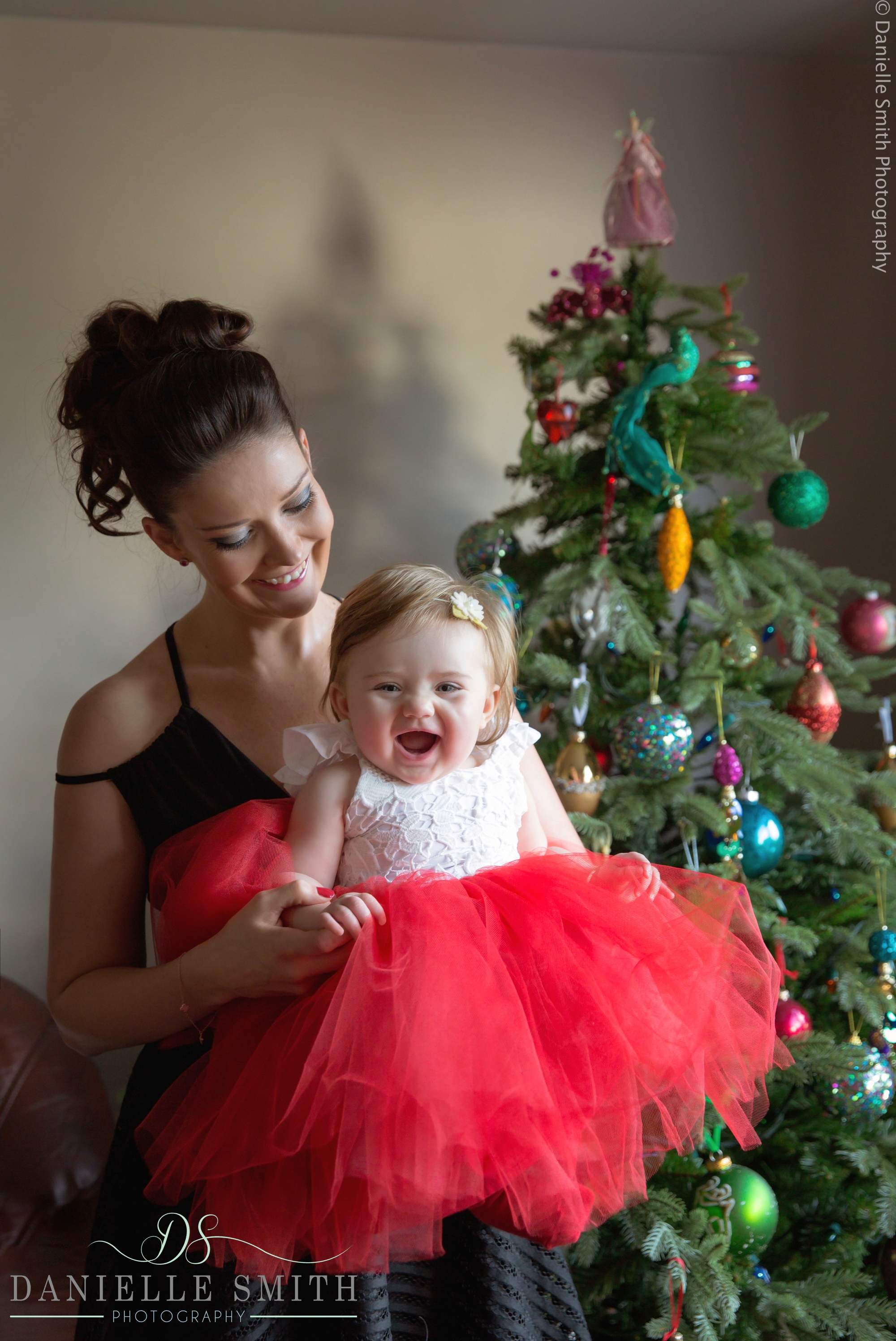 mum holding her little girl at christmas