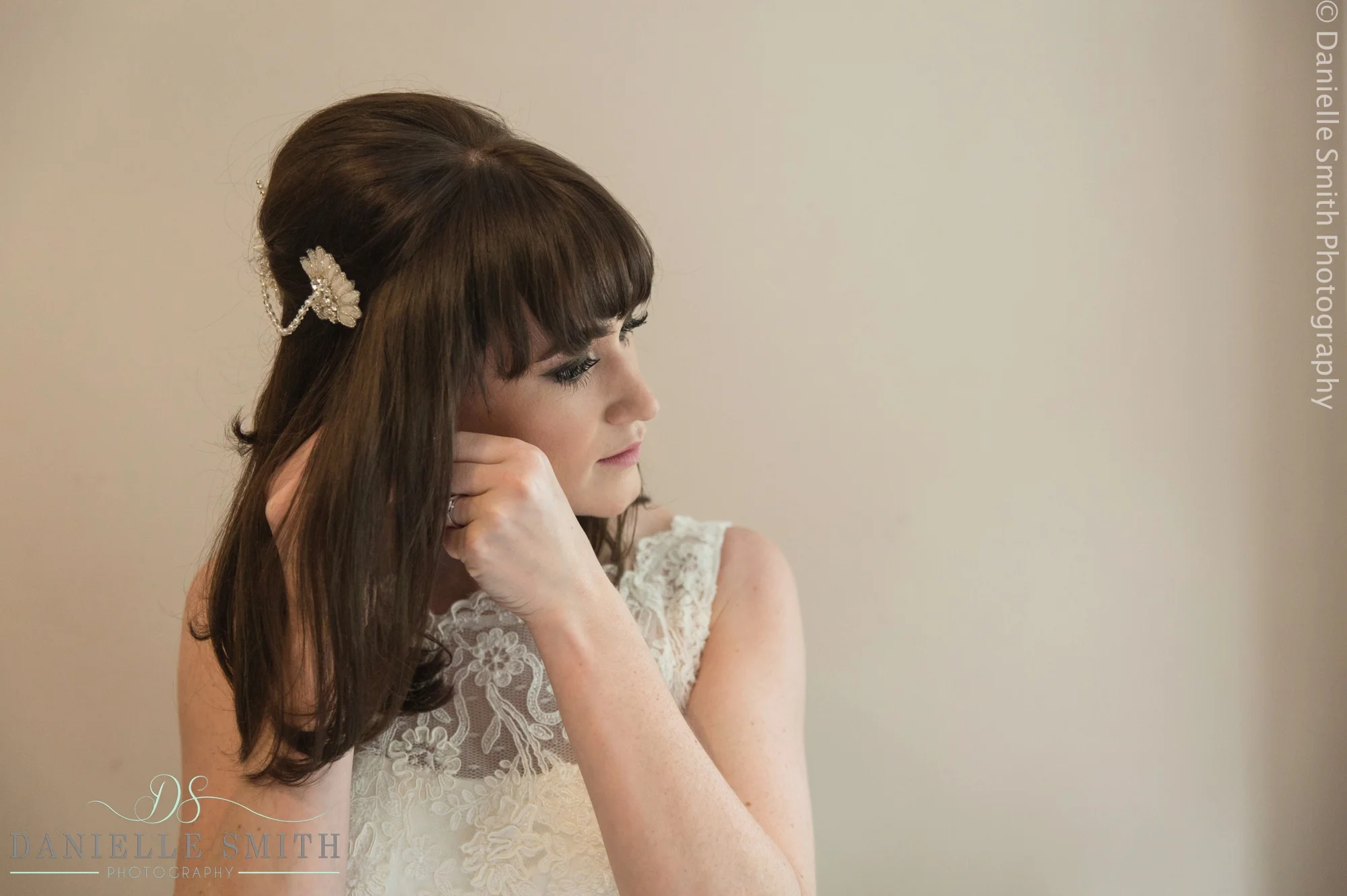 bride putting earrings in