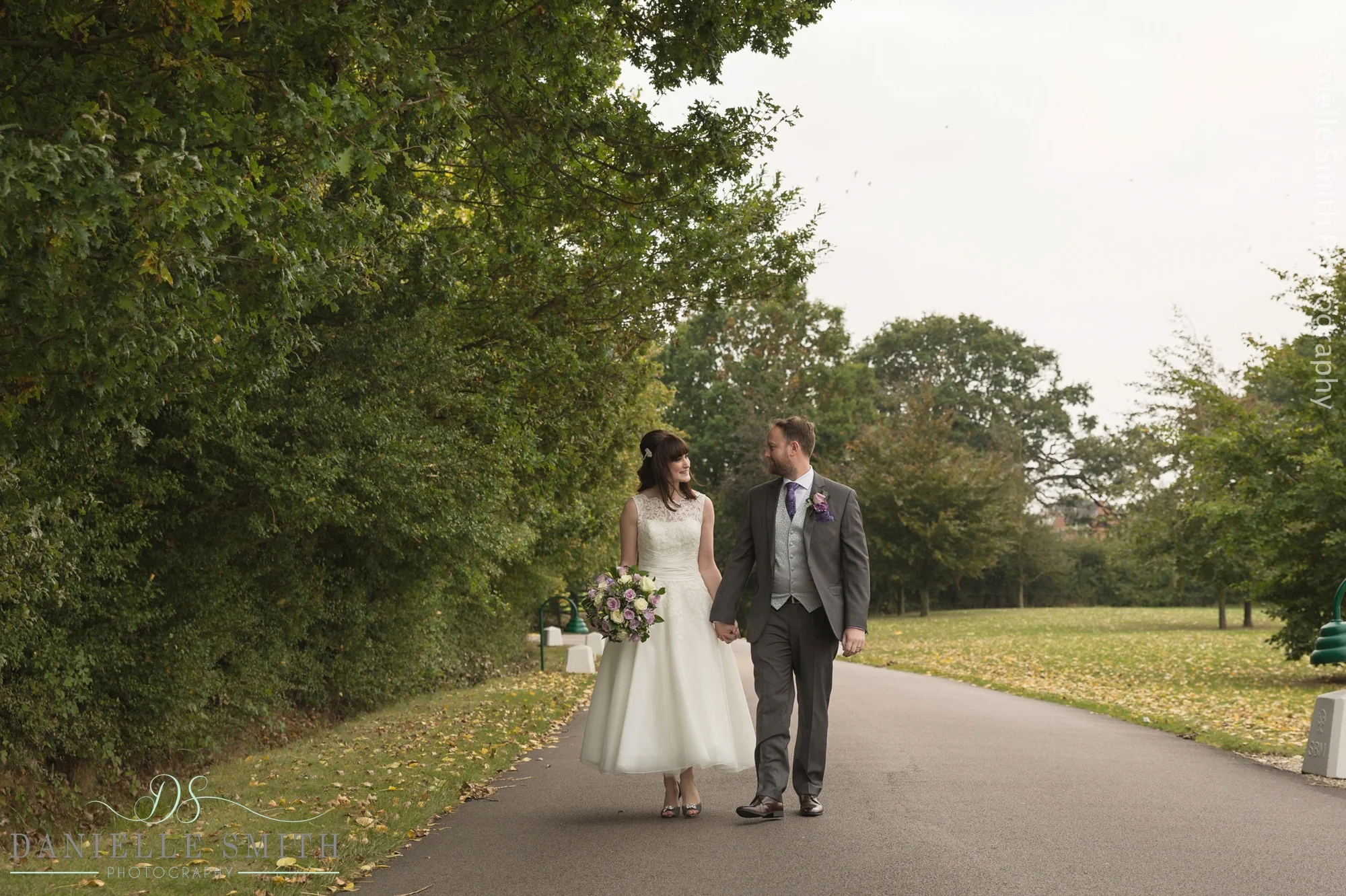 bride and groom walking down path