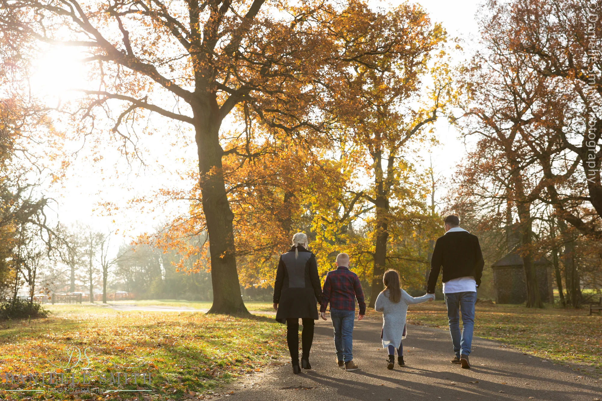 family of 4 walking in autumn park