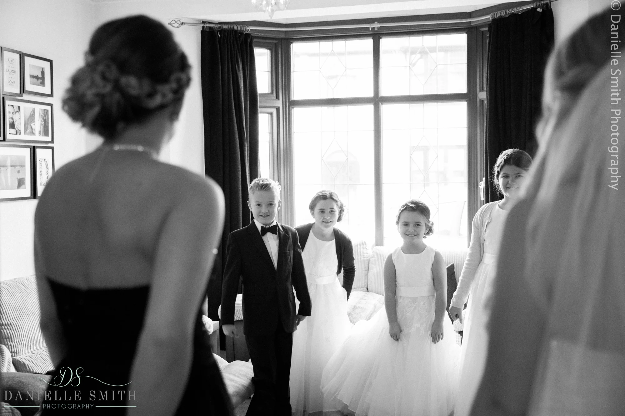 flower girls and page boy seeing bride in her dress